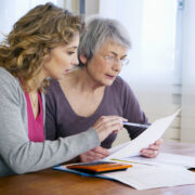 patient-advocate-helping-elderly-parent-review-medical-bill