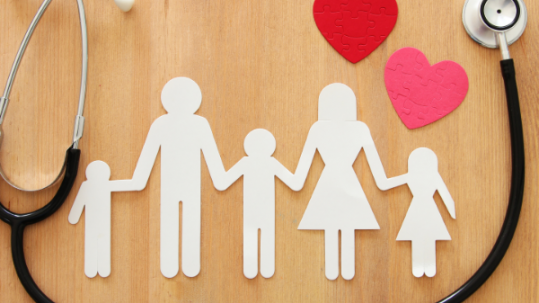 Free health insurance. A paper family holding hands.
