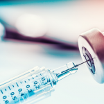 A shingles vaccine is drawn with a needle from a clear vial, now covered by the inflation reduction act, or ira