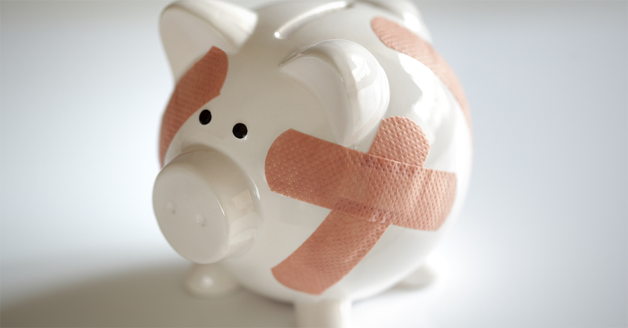 A white piggy bank with bandaids on it, representing how to crush medical debt.