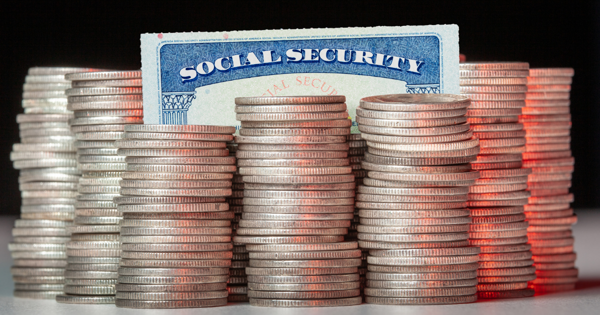 A social security card is sitting upright with quarters surrounding it, representing navigating ssdi and ssi during the pandemic.