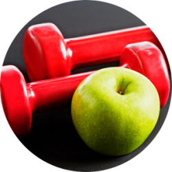 A pair of red weights sit next to a green apple, representing the food and fitness for the cancer survivor webinar.