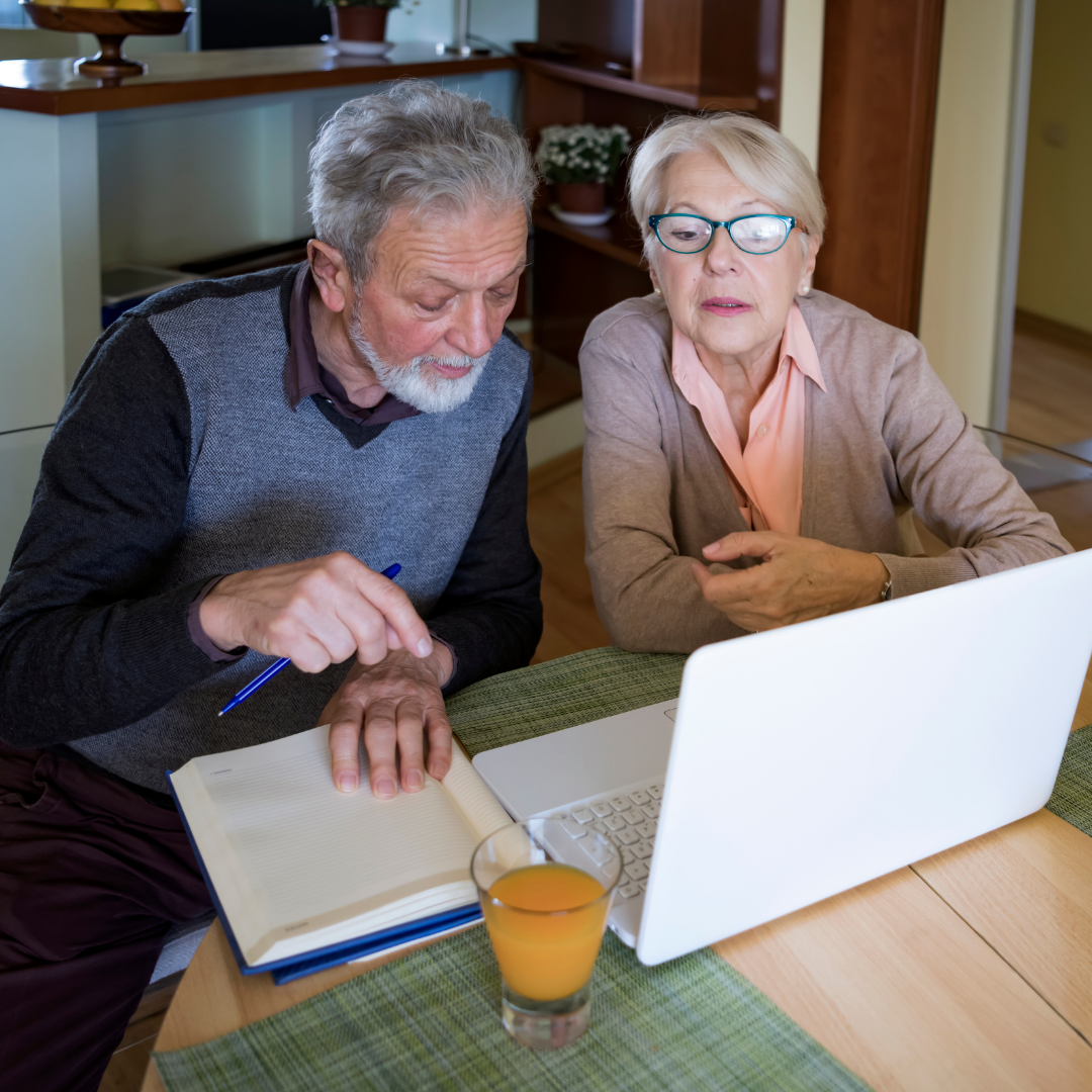 An older couple sits at the kitchen table looking at hospital prices made available through the Hospital Price Transparency Rule