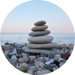 Several smooth stones stacked on top of each other on a rocky beach