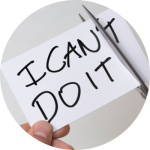 A person is cutting a piece a paper so it says "I can do it," instead of "I can't do it."