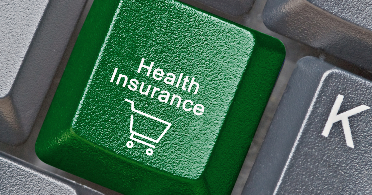 A green button on a black keyboard says "health insurance" with a shopping cart below it.