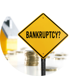 A bright yellow road sign that says "bankruptcy" sits in front of a stack of coins and a home.