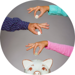 Three people drop coins into a piggybank