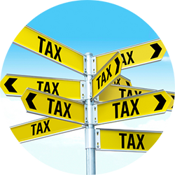 A street sign has multiple "tax" signs that are bright yellow and pointing in all different directions.