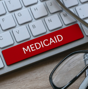 A keyboard with a bright red "medicaid" key in place of the space bar.