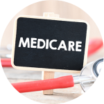 The word "Medicare" is written on a tiny chalk board with a stethoscope surrounding it.