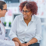 A doctor and her patient are sitting and talking