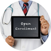 A doctor is holding a tablet that says "Open Enrollment"