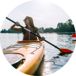 A woman is on a kayaking adventure on a sunny day