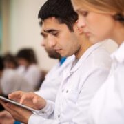 Photo of doctors typing on a tablet