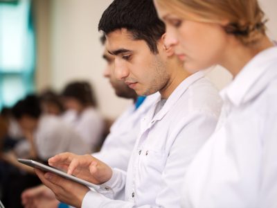 Photo of doctors typing on a tablet