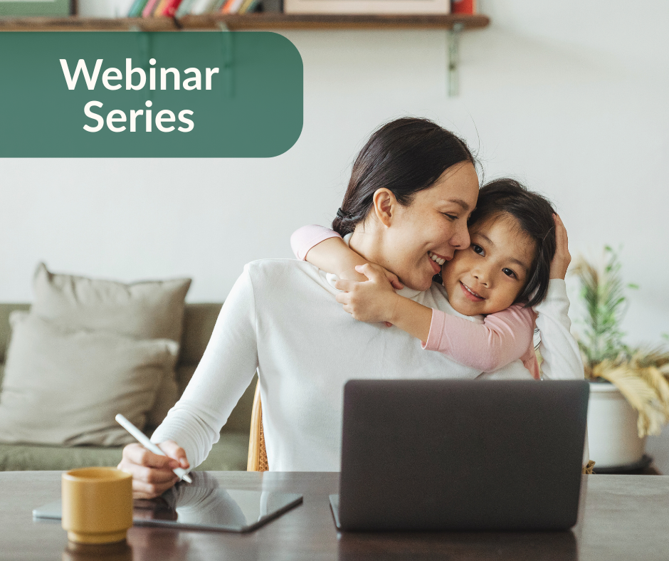 A woman and child sitting in front of a laptop, with the child hugging her neck.