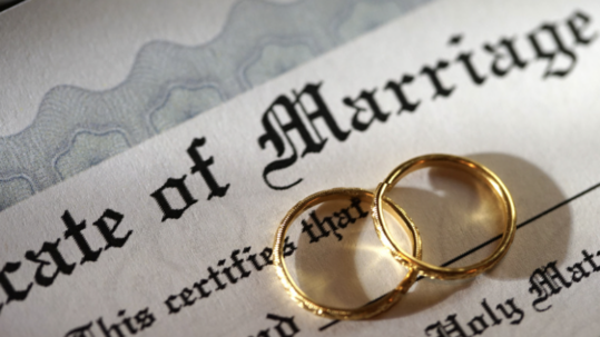 marriage certificate with two wedding bands