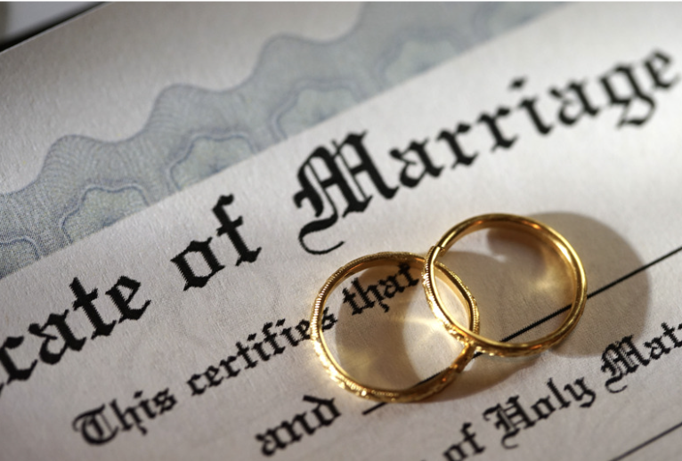 marriage certificate with two wedding bands