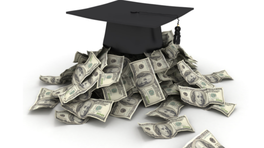 grad cap on top of a pile of money